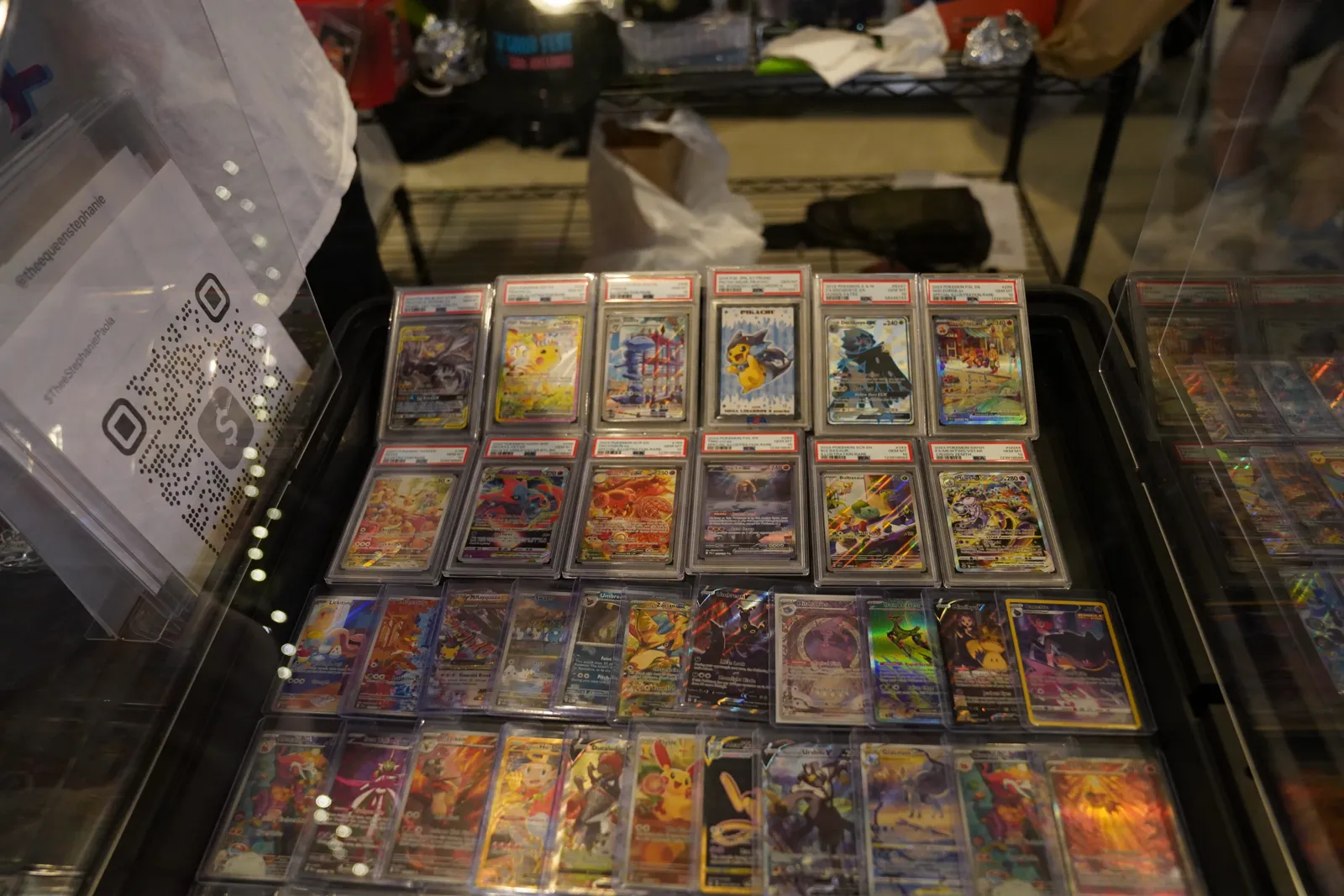 Close-up of rows of graded Pokémon card slabs in a display case
